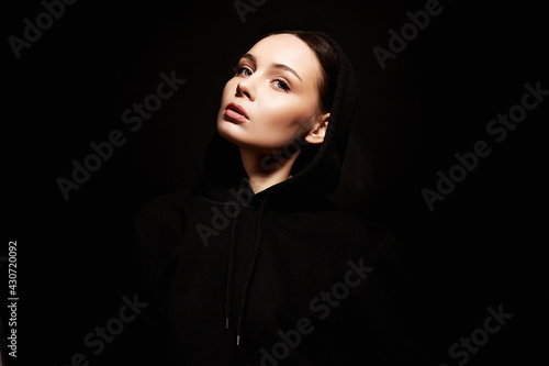 portrait of beautiful young woman in hood