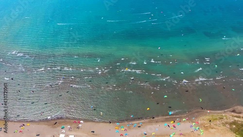 Wallpaper Mural Kiteboarding kitesurfing kiter and kiteboarder is pulled across water by power kite.Kiteboarders kiteboard kitesurfers beach kitesurfer surfing kiters sea sport wind windsurfing foil lei bow aerial 4K Torontodigital.ca