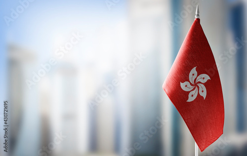 A small flag of Hong Kong on the background of a blurred background