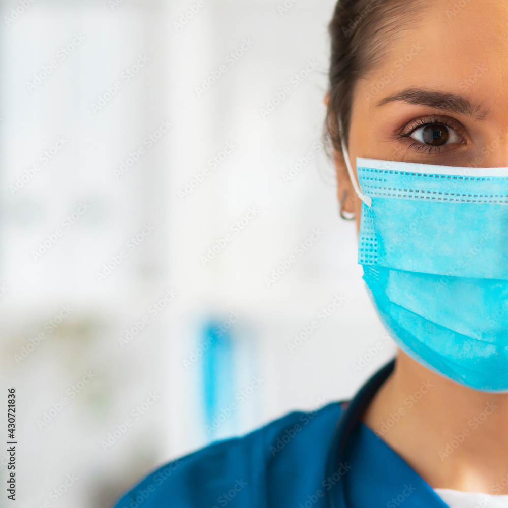 Professional medical doctor working in hospital office, Portrait of young and attractive female physician in protective mask. Professional medical doctor working in hospital office, Portrait of young and attractive female physician in protective mask.