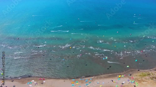 Wallpaper Mural Kiteboarding kitesurfing kiter and kiteboarder is pulled across water by power kite.Kiteboarders kiteboard kitesurfers beach kitesurfer surfing kiters sea sport wind windsurfing foil lei bow aerial 4K Torontodigital.ca