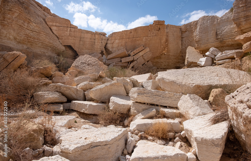 Panoramic view inside a dry wadi Daras in a remote region of the Negev desert. Impressive huge boulders of unusual shapes. Hiking trail in a heart of a desert. Nature reserve. Panoramic view inside a dry wadi Daras in a remote region of the Negev desert. Impressive huge boulders of unusual shapes. Hiking trail in a heart of a desert. Nature reserve.