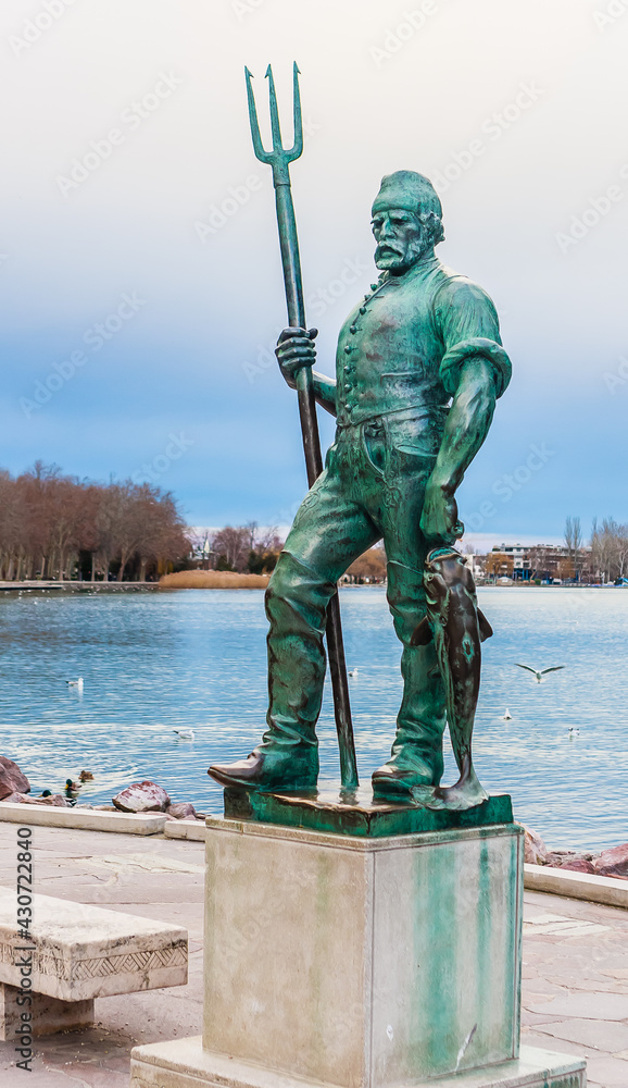 Figure of fishman on the shore of Balaton lake in Balatonfured, Hungary
