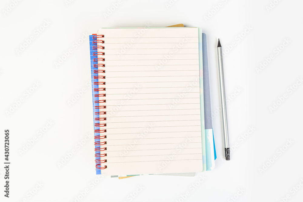 top view of an open notebook with a pencil on a gray background, school notebooks with a spiral spring, office notepad. desktop concept, learning top view of an open notebook with a pencil on a gray background, school notebooks with a spiral spring, office notepad. desktop concept, learning