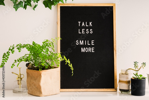 letterboard with the message, talk less smile more photo