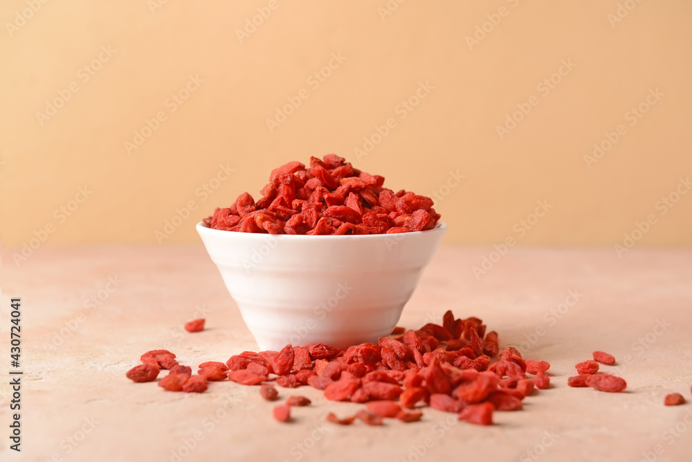 Bowl with dried goji berries on color background Bowl with dried goji berries on color background