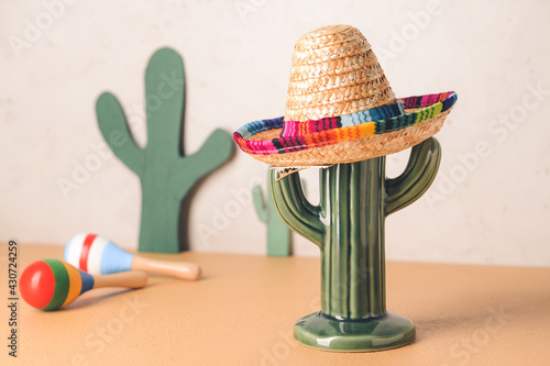 Cactus, maracas and sombrero hat on light background