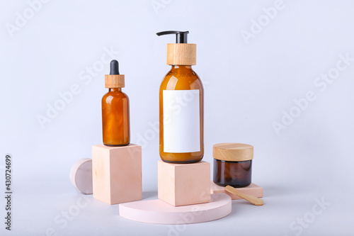 Bottles of cosmetics for hair on white background