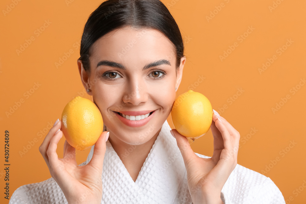 Beautiful young woman with lemons on color background Beautiful young woman with lemons on color background