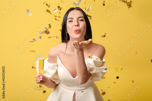 Happy young woman blowing k...