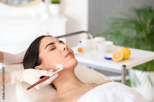 Cosmetologist applying mask...