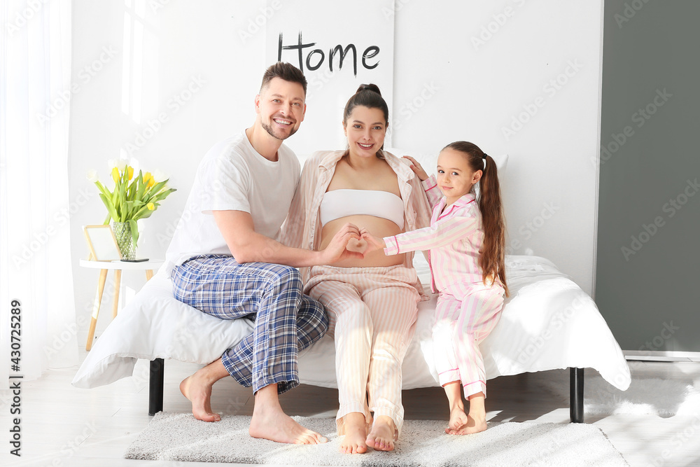 Young pregnant woman with her family at home Young pregnant woman with her family at home