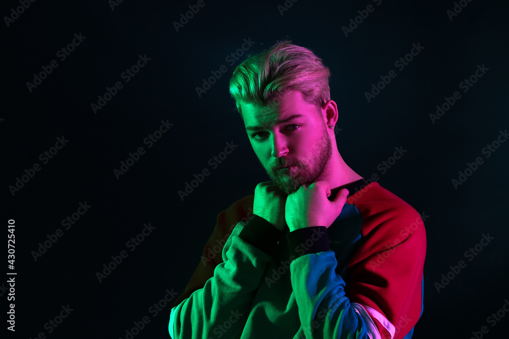 Toned portrait of handsome young man on dark background Toned portrait of handsome young man on dark background