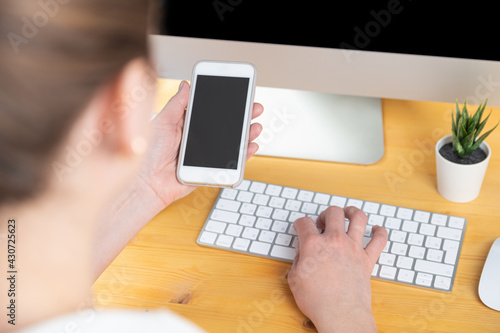 hands of women who use laptop keyboard and mobile phone. concept of email delivery and use of online technology