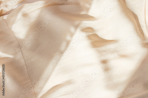 Abstract beige background flat layout. Modern minimalistic background with crumpled fabric texture and cotton folds. Top view for presentation