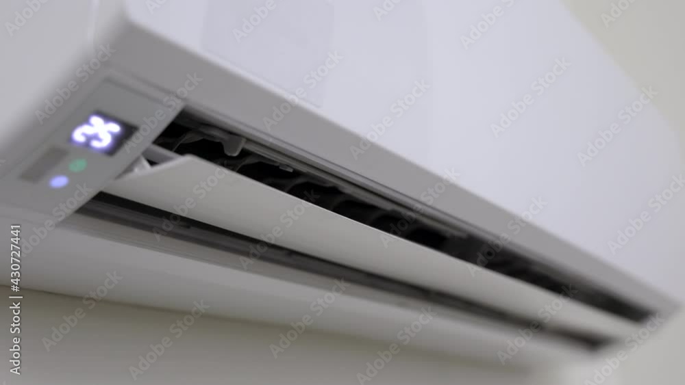 The young man used remote turn on the air conditioning . Adjust the temperature to cool. In the living room at home
The young man used remote turn on the air conditioning . Adjust the temperature to cool. In the living room at home