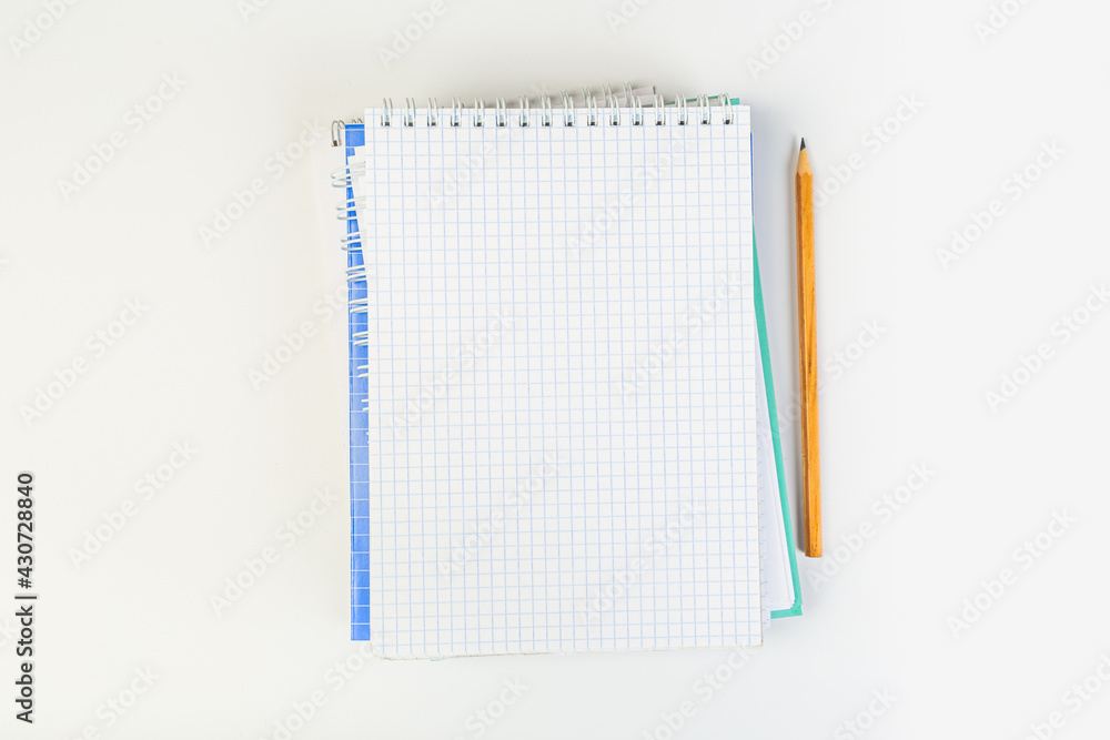 top view of an open notebook with a pencil on a gray background, school notebooks with a spiral spring, office notepad. desktop concept, learning top view of an open notebook with a pencil on a gray background, school notebooks with a spiral spring, office notepad. desktop concept, learning