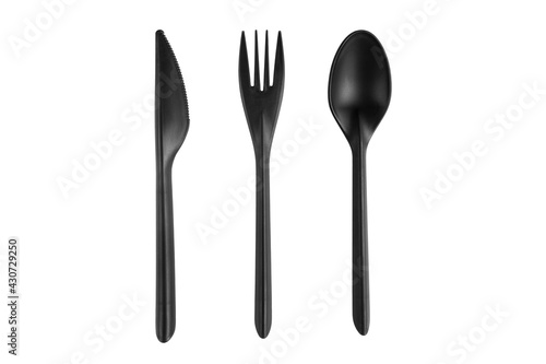 Black plastic spoon, knife and fork isolated on white background. Disposable tableware set isolated with clipping path.