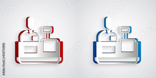 Paper cut Cashier at cash register supermarket icon isolated on grey background. Shop assistant, cashier standing at checkout in supermarket uniform. Paper art style. Vector