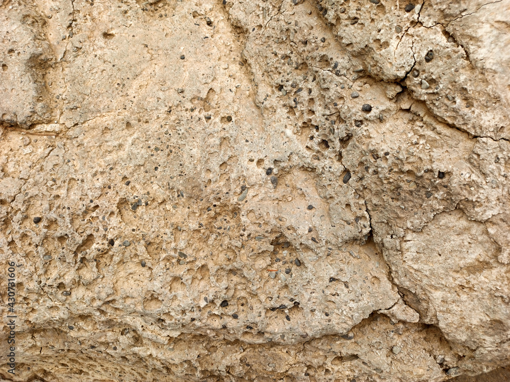 textured sand-colored stone wall background