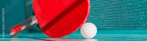Red racket and a ball for table tennis