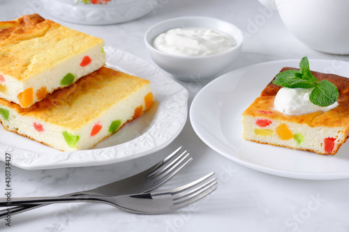 Healthy breakfast - cottage cheese casserole or baked pudding with fresh mint and sour cream. Traditional russian zapekanka.