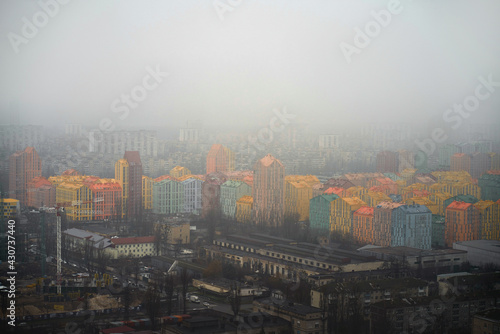 Aerial view of infrastucture in the colorful modern city. Comfort town Kyiv Ukraine. Foggy dull day in the capital city