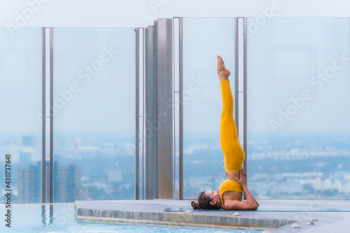 woman pratice yoga workout training pose show body flexibilty and balance photo