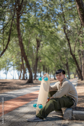 Portrait of Asian man with Surfskate