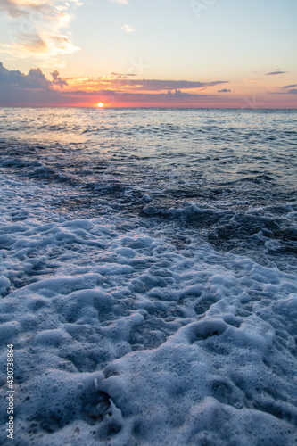 Water by the sea at sunset.