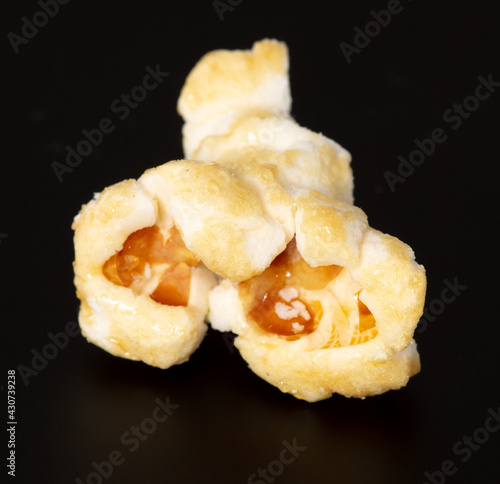 Close-up of popcorn flakes on a black background.