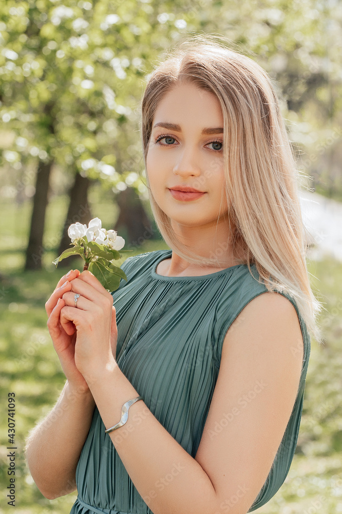 Cheerful young woman with the flowers of apple tree Cheerful young woman with the flowers of apple tree