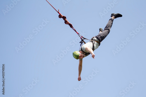  A man jumps from a bridge on a rope. Extreme sports.