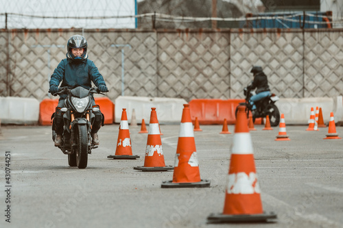 motorcycle driving school. a woman learns to drive before obtaining a driving license. 