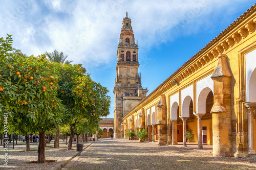 Cordoba, Spain. View of Torre Campanario - historical bell tower and courtyard planted with orange trees photo