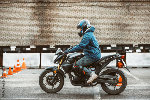 motorcycle driving school. a woman learns to drive before obtaining a driving license. 