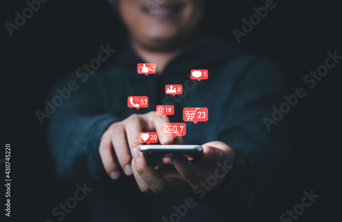 Man holding smartphone with Social media and business icons , technology and marketing concept.