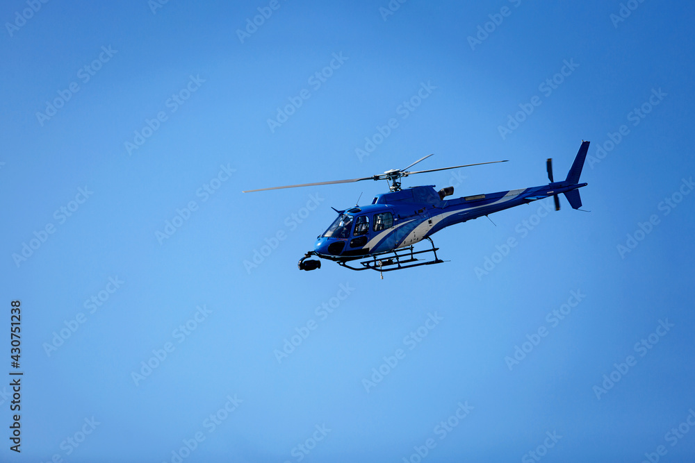 Fototapeta premium Helicopter on the right against a clear blue sky