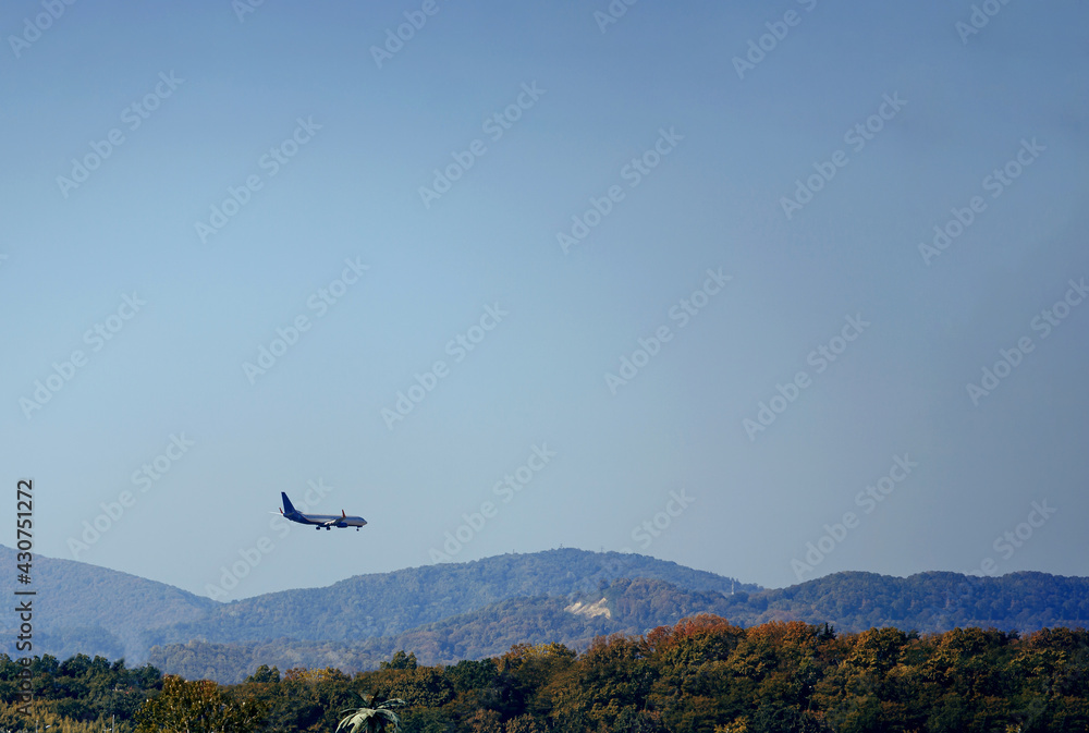 Plane land on the background of the sky and mountains Plane land on the background of the sky and mountains