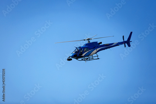 Fototapeta Naklejka Na Ścianę i Meble -  Helicopter on the right against a clear blue sky