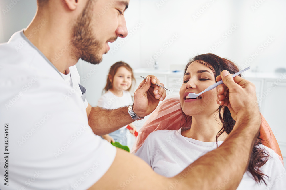 Woman visiting dentist in clinic. Conception of stomatology Woman visiting dentist in clinic. Conception of stomatology