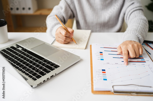businesswoman working about analysis financial statements, business document, chart and graph paper, accounting concept.