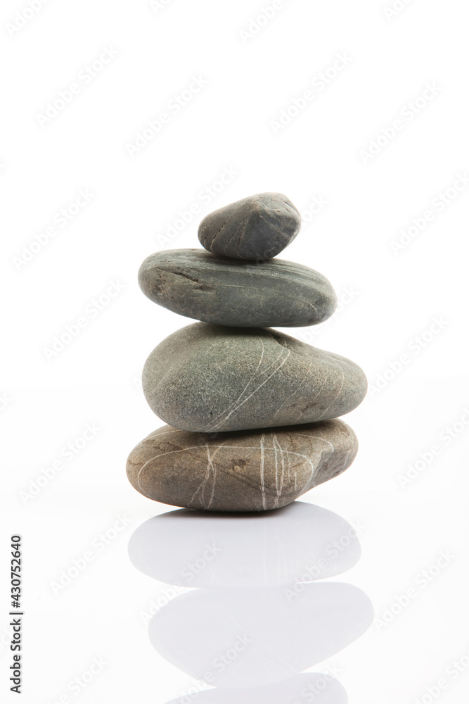 Stones standing in balance on grey background Stones standing in balance on grey background
