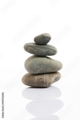 Stones standing in balance on grey background
