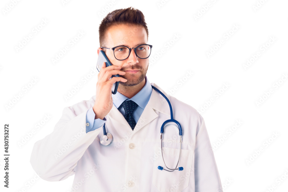 Male doctor studio portrait while talking on phone and standing at isolated background Male doctor studio portrait while talking on phone and standing at isolated background