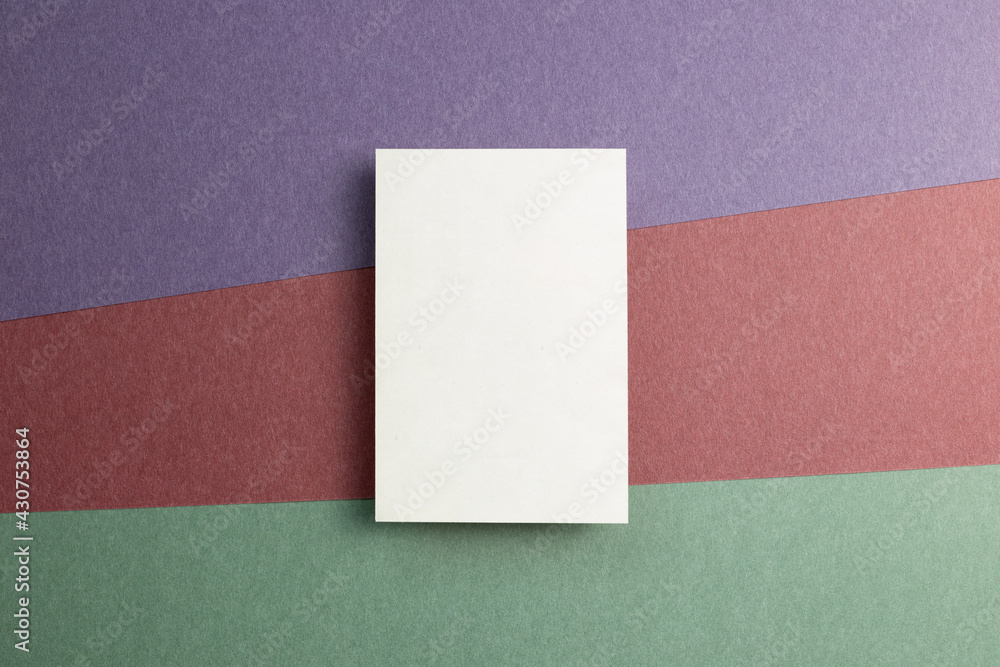 White memo pad on color paper background. top view, copy space