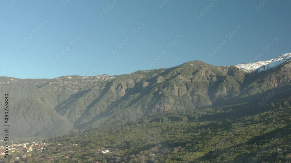 Town of Puerto de la Cruz at the foot of El Teide Volcano, Tenerife Canary islands Spain, Aerial flyover shot Town of Puerto de la Cruz at the foot of El Teide Volcano, Tenerife Canary islands Spain, Aerial flyover shot