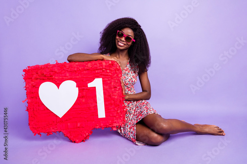 Full length body size photo model wearing red sunglass showing heart like icon sitting barefoot isolated pastel violet color background