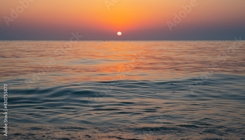 Fototapeta Naklejka Na Ścianę i Meble -  Colorful vibrant ocean beach sunrise during a summer day. beautiful sunrise