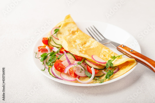 Stuffed vegetable omelette - cucumber  tomato  radish  onions and pea sprouts. Healthy breakfast.